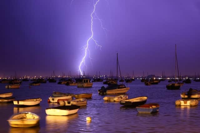 Lightning strikes over a harbour during a thunderstorm. (Pic credit: Dan Kitwood / Getty Images)