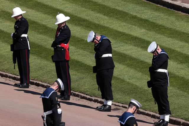 Troops stood with their heads bowed as the funeral procession passed (Photo: Hannah McKay)