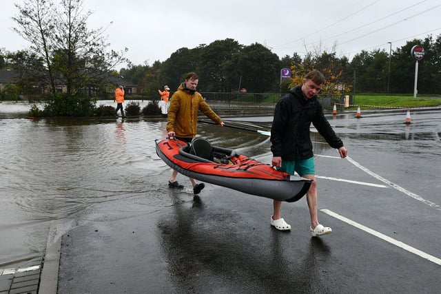 Intrepid cousins Thomas Grozier, 27, of Bainsford, left, and Ben Brown, 21, of Whitecross, took to the water in their kayak as the car park at Cadgers Brae was flooded.