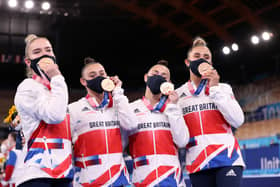 Alice Kinsella, Jessica Gadriova, Jennifer Gadriova and Amelie Morgan of Team Great Britain celebrate with their bronze medals (Photo by Laurence Griffiths/Getty Images)