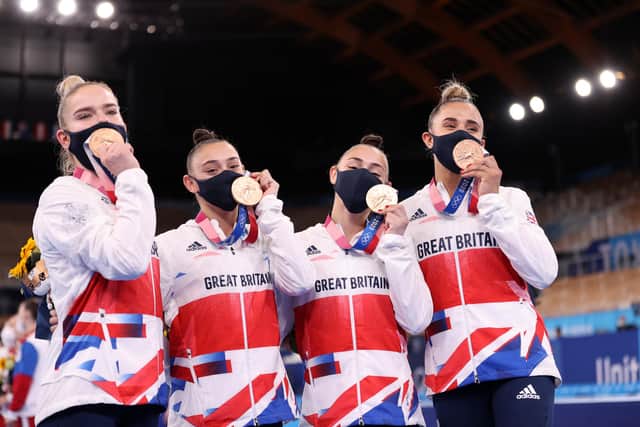 Alice Kinsella, Jessica Gadriova, Jennifer Gadriova and Amelie Morgan of Team Great Britain celebrate with their bronze medals (Photo by Laurence Griffiths/Getty Images)