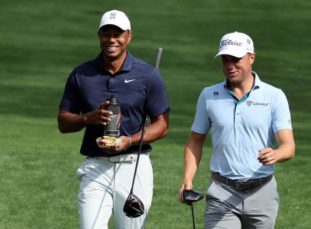 Tiger Woods and Justin Thomas share a joke during a practice round on Monday at Augusta. 