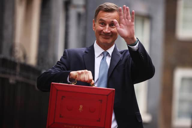 Chancellor Jeremy Hunt leaves Downing Street to present his spring budget to Parliament.