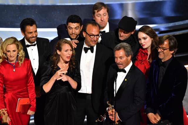 "Coda" cast and crew accept the award for Best Picture onstage during the 94th Oscars (Photo by ROBYN BECK/AFP via Getty Images)