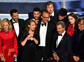 "Coda" cast and crew accept the award for Best Picture onstage during the 94th Oscars (Photo by ROBYN BECK/AFP via Getty Images)