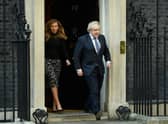 Prime Minister Boris Johnson and his partner Carrie Symonds stand outside the door of number 10 Downing Street (Photo by Leon Neal/Getty Images)