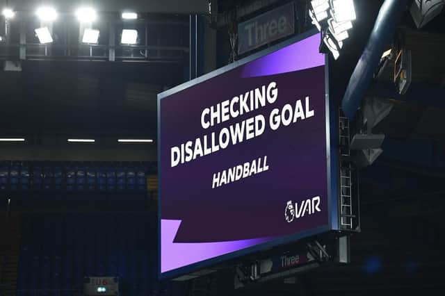 A general view inside the stadium of the LED Screen indicating that the goal scored by Kai Havertz of Chelsea (not pictured) is being reviewed by VAR for a potential handball during the Premier League match between Chelsea and Everton at Stamford Bridge on March 08, 2021 in London, England.