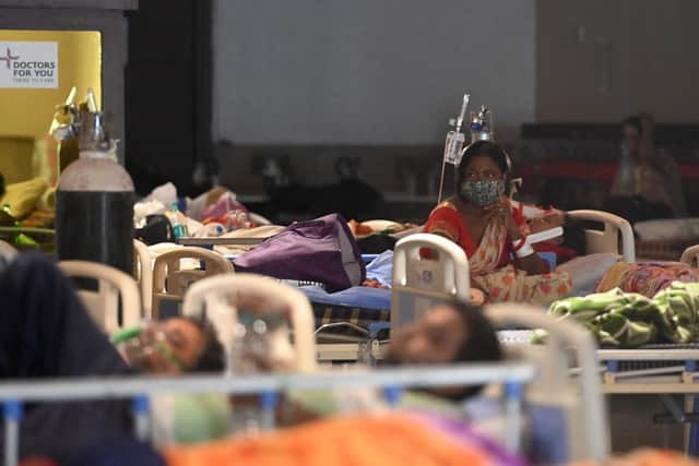Patients rest inside a banquet hall temporarily converted into a Covid-19 coronavirus ward in New Delhi on April 27, 2021. (Money SHARMA / AFP/ Getty Images)