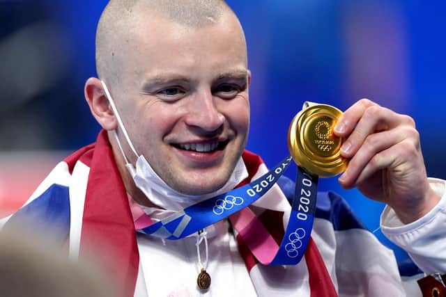 Great Britain's Adam Peaty poses with his gold medal on the podium after winning the Men's 100m Breaststroke final at the Tokyo Aquatics Centre on the third day of the Tokyo 2020 Olympic Games in Japan (PA)