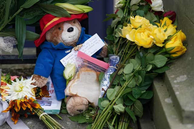 A toy Paddington Bear and a marmalade sandwich, a nod to the Queen's association with the children's book character at the Royal Jubilee, laid outside the Palace of Holyroodhouse in Edinburgh. Queen Elizabeth II's coffin is travelling from Balmoral to Edinburgh, where it will lie at rest at the Palace of Holyroodhouse.