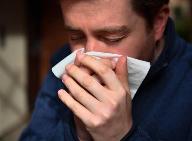 <p> PICTURE POSED BY MODEL
A man sneezes into a tissue. PA Photo. Picture date: Saturday March 14, 2020. Photo credit should read: Ben Birchall/PA Wire </p>