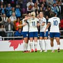 England players congratulate Lauren Hemp after scoring their second goal against Scotland in the UEFA Nations League.