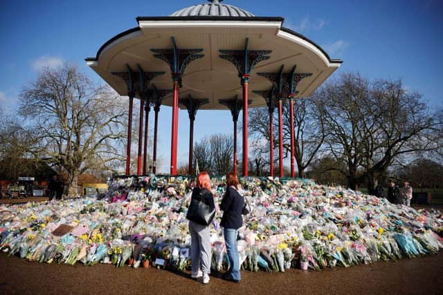 Well-wishers place floral tributes and messages in honour of Sarah Everard at the bandstand on Clapham Common in south London (Photo: TOLGA AKMEN/AFP via Getty Images)
