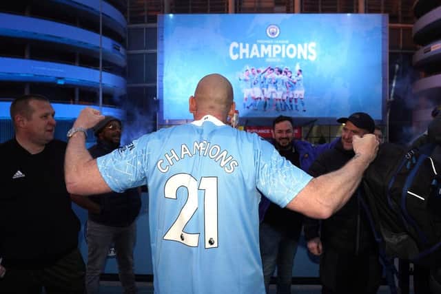 Manchester City fans celebrate after their team was confirmed as Premier League champions for the third time in four seasons.