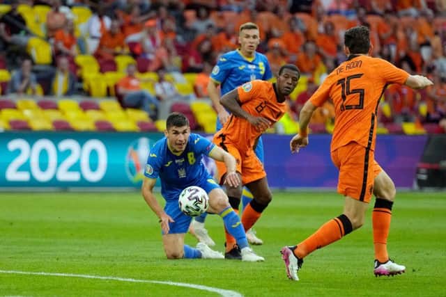 Ukraine's midfielder Ruslan Malinovskyi vies for the ball with Netherlands' midfielder Georginio Wijnaldum during their group game.