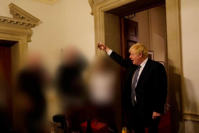Mr Johnson raises a toast during a gathering at No 10 Downing Street.