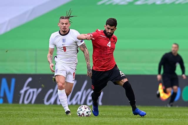 Kalvin Phillips of England battles for possession with Elseid Hysaj of Albania during the World Cup qualifying match at the Qemal Stafa Stadium in Tirana, Albania.
