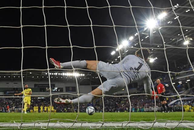 Chelsea's Spanish goalkeeper Kepa Arrizabalaga dives to save the penalty of Villarreal's Spanish defender Raul Albiol to win the Super League shoot out.