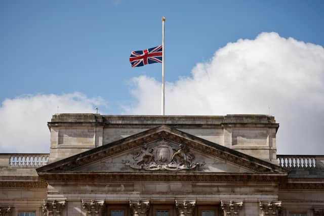 Union flags at royal residences and on government buildings were lowered to half-mast on Friday (Photo by TOLGA AKMEN/AFP via Getty Images)