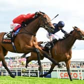 Ryan Moore rides Tuesday (R) to victory over Frankie Dettori and Emily Upjohn (L) in the Oaks last month. Photo by GLYN KIRK/AFP via Getty Images