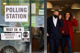 Labour party leader Keir Starmer and partner Victoria leave a polling station after casting their vote in local elections in London (Photo by Tolga Akmen / AFP)
