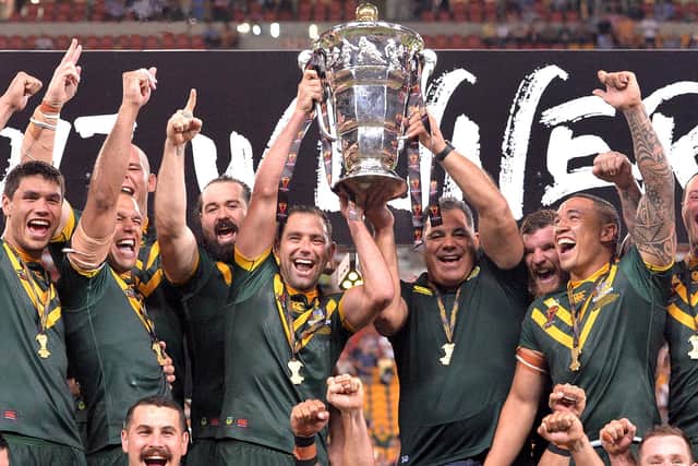The Australian Kangaroos celebrate victory as captain Cameron Smith holds up the world cup trophy after the 2017 Rugby League World Cup Final between the Australian Kangaroos and England at Suncorp Stadium on December 2, 2017 in Brisbane, Australia. (Photo by Bradley Kanaris/Getty Images)