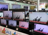 TV screens showing a news report about North Korea's missiles