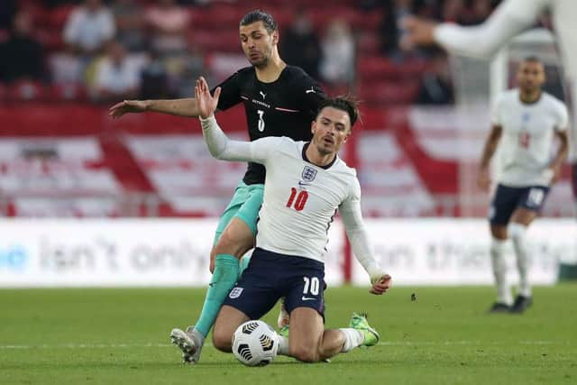 Austria's defender Aleksandar Dragovic vies with England's striker Jack Grealish.