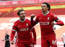 Trent Alexander-Arnold celebrates with Liverpool teammate Xherdan Shaqiri after keeping their Champions League bid intact with a last-gasp winner over Aston Villa.